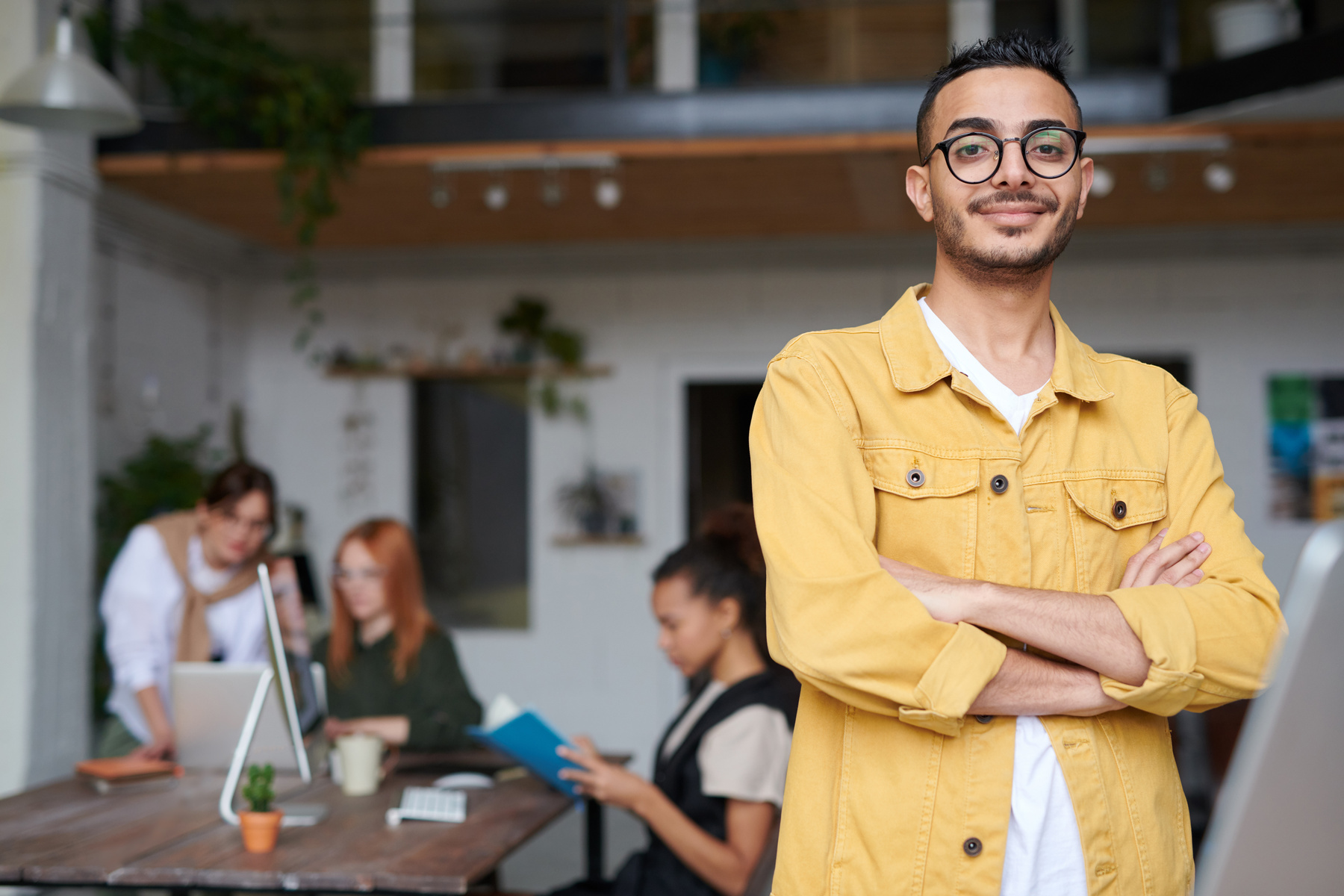 Man in Brown Jacket Standing Near Table